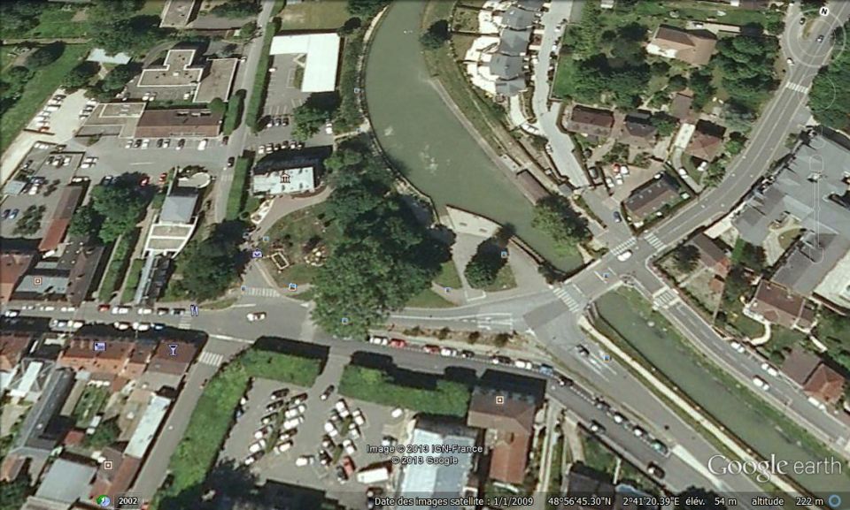 Aerial view of a town with a river and roads