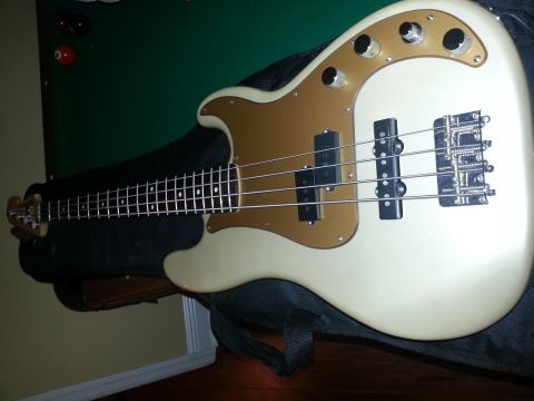 1994 Ford Bronco - An electric bass guitar is shown with its body, neck, and hardware visible.