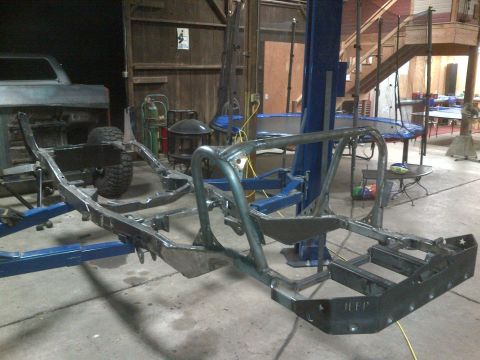 1985 Jeep CJ7 - Custom roll cage fabrication on a Jeep CJ frame in a workshop setting.