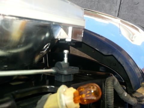 1994 Ford Bronco - A close-up view of a vehicle's headlight assembly and fender, showing an amber bulb.