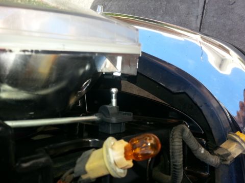 1994 Ford Bronco - Close-up of a vehicle's headlight assembly, showing an amber bulb and chrome accents. The registry claims it's a 1994 Ford Bronco.