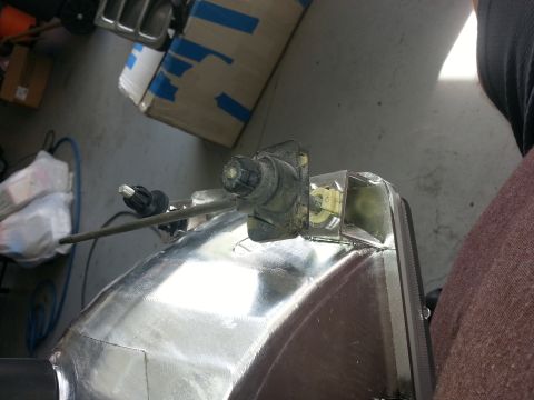 1994 Ford Bronco - Detail of a vehicle headlight assembly mechanism, showing internal components and wiring.