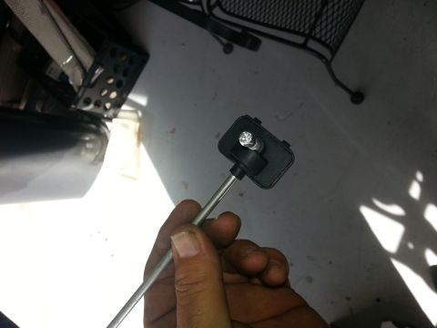 1994 Ford Bronco - A close-up of an automotive sensor part, held in a person's hand.