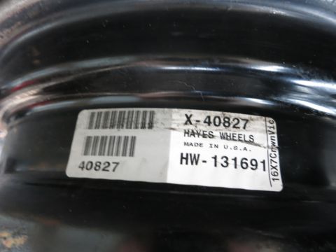 2001 Ford Crown Victoria - A close-up of a black wheel shows a label with part numbers and manufacturer information.
