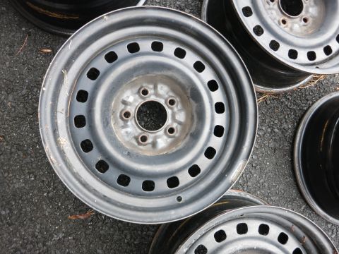 2001 Ford Crown Victoria - A collection of steel wheels, likely for a car or truck, are shown from a top-down perspective.