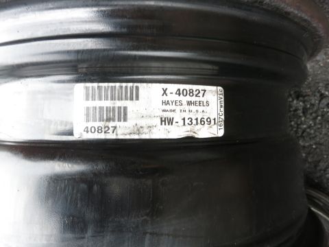 2001 Ford Crown Victoria - A sticker on a wheel rim shows part numbers and manufacturer information.