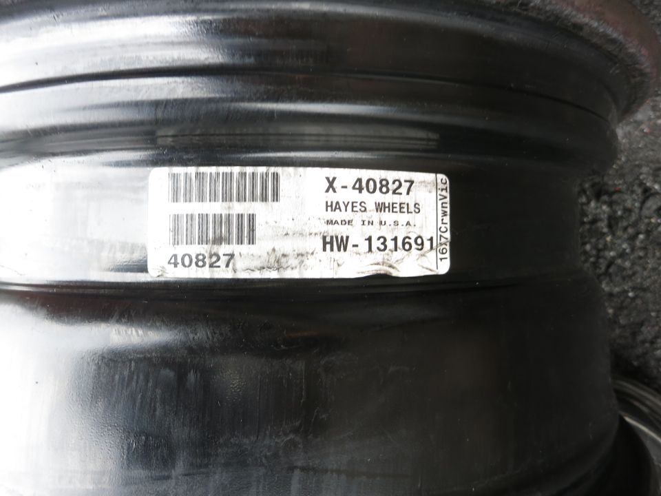 Close-up of a sticker on a black wheel rim. Sticker reads X-40827 HAYES WHEELS MADE IN U.S.A. HW-131691
