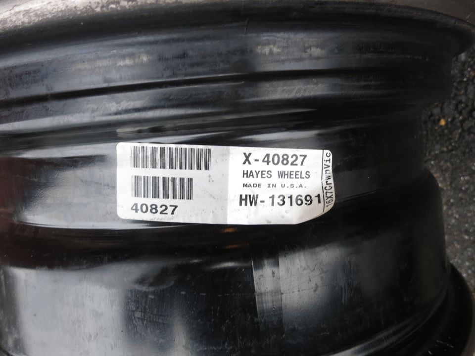 Black steel wheel with a label that reads "HAYES WHEELS X-40827 HW-131691 16X7CrwnVic"