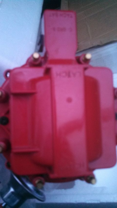 1979 Ford Bronco - A red ignition coil is shown, with some text visible on its upper section.