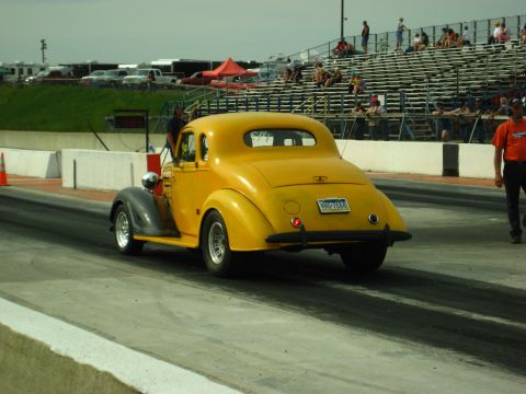 1935 Chevrolet New - Yellow 1935 Chevrolet New coupe hot rod at a drag strip event.