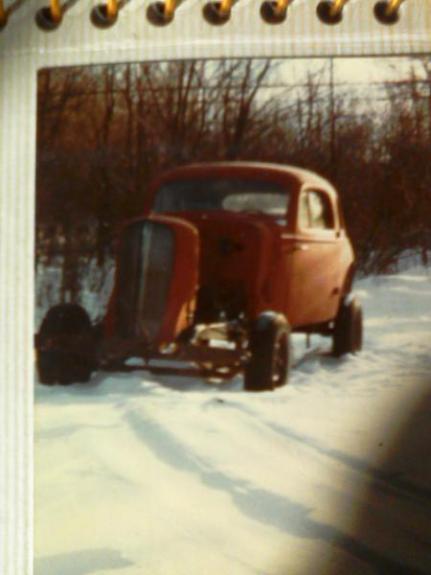 1935 Chevrolet new - A red 1935 Chevrolet hot rod sits in the snow, its hood open.