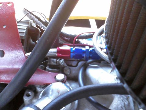 1935 Chevrolet new - Close-up view of engine components, including fuel lines and an air filter.