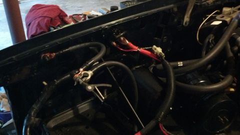 1993 Ford Bronco - Close-up view of the engine bay wiring and battery connections.
