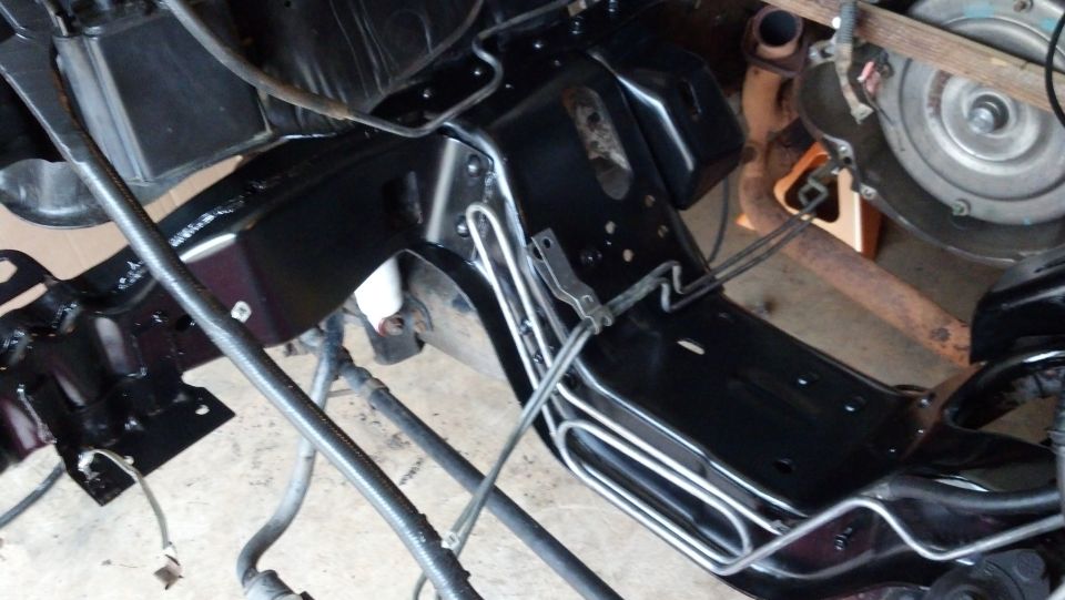 Close-up of vehicle frame and transmission assembly, possibly during a rebuild