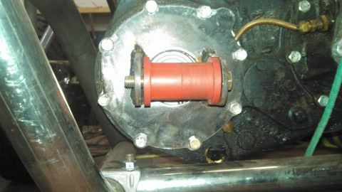 1982 Ford F-100 - Close-up of a transmission component with a red bushing and brass fittings.