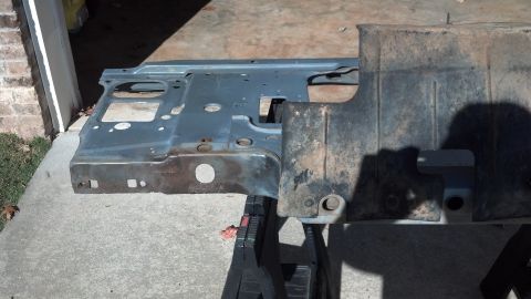 1993 Ford Bronco - A section of a vehicle's frame, possibly from a Ford Bronco, is shown disassembled and resting on sawhorses.