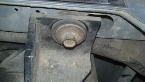 1993 Ford Bronco - Close-up of a frame mount with a bolt, likely from a vehicle's undercarriage.