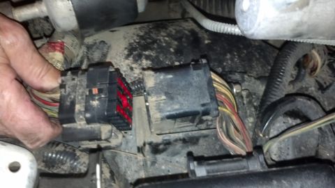 1993 Ford Bronco - Engine bay wiring harness connectors being disconnected.