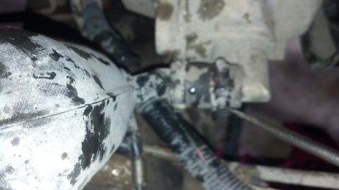 1993 Ford Bronco - Engine part with hoses, likely from a vehicle undergoing maintenance.