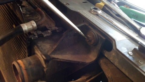 1993 Ford Bronco - Tools are placed on top of engine bay components near the radiator.