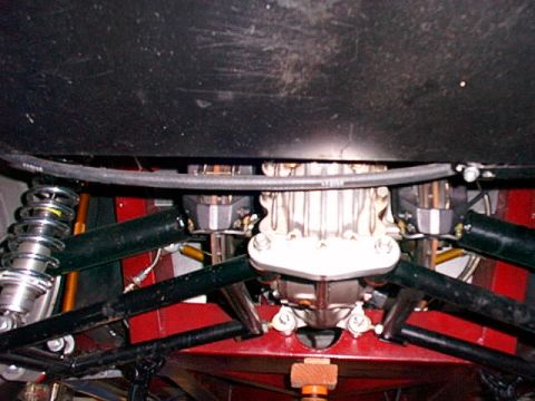1967 Ford 427 - Close-up of a vehicle's rear differential and suspension system, showing intricate mechanical parts.
