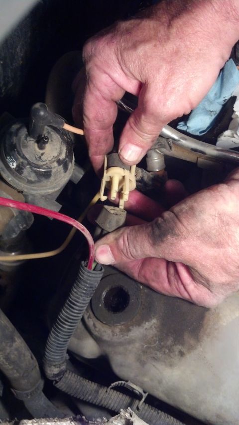 1993 Ford Bronco - Mechanic disconnects a wiring harness during a vehicle tear down.