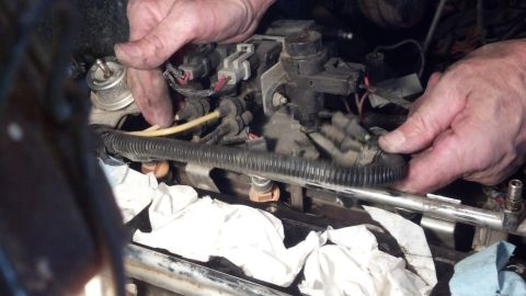 1993 Ford Bronco - Close-up of engine fuel rail and injectors during a repair or maintenance procedure.