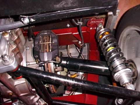 1967 Ford 427 - Close-up view of a vehicle's rear axle assembly, showing suspension and braking parts.