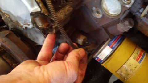 1993 Ford Bronco - Close-up of an engine part with a yellow oil filter visible.