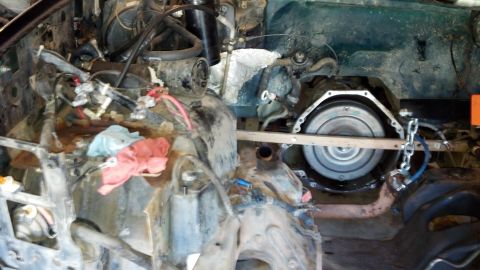 1993 Ford Bronco - Disassembled engine bay showing transmission and associated components, likely during a tear-down or repair process.