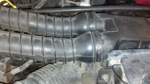 1993 Ford Bronco - Close-up view of engine air intake hoses and associated components.