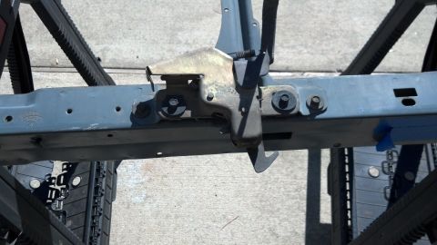 1993 Ford Bronco - A close-up view of a vehicle's structural frame component, a latching mechanism.