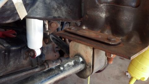 1993 Ford Bronco - This image shows a close-up view of the suspension system, a shock absorber and various metal components.