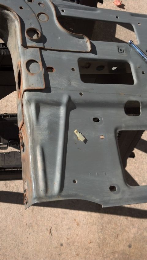 1993 Ford Bronco - This is a close-up view of a vehicle's frame section, showing metalwork and some signs of wear.