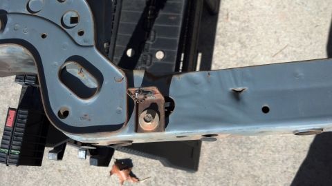 1993 Ford Bronco - Close-up of a vehicle frame component, showing signs of wear and tear.