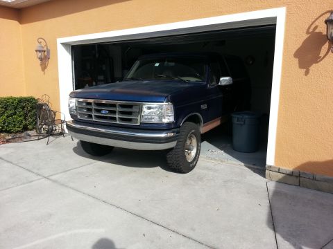 1994 Ford Bronco - This 1994 Ford Bronco is parked in a garage, showing its front three-quarter view.