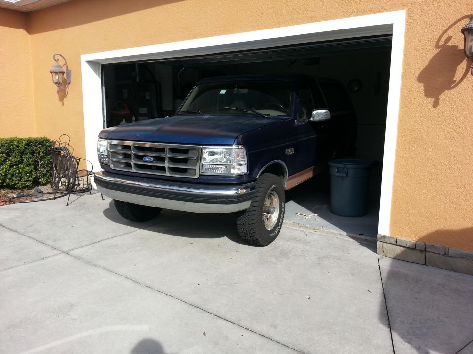Blue 1994 Ford Bronco parked in garage