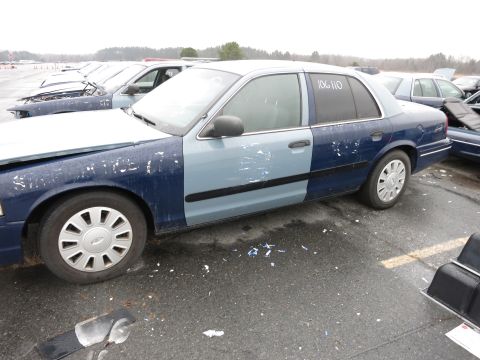 1991 Ford LTD Crown Victoria - Side view of a two-tone Ford Crown Victoria, likely a later model, in a vehicle lot.