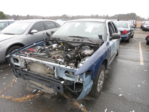 1991 Ford LTD Crown Victoria - A blue Ford Crown Victoria sits in a lot with its hood open, showing the engine and missing front bumper.