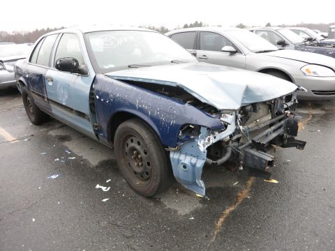 1991 Ford LTD Crown Victoria - This sedan has significant front-end damage and appears to be in a junkyard or impound lot.