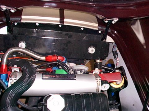 1967 Ford 427 - Close-up of an accusump oil accumulator with associated plumbing and gauges.