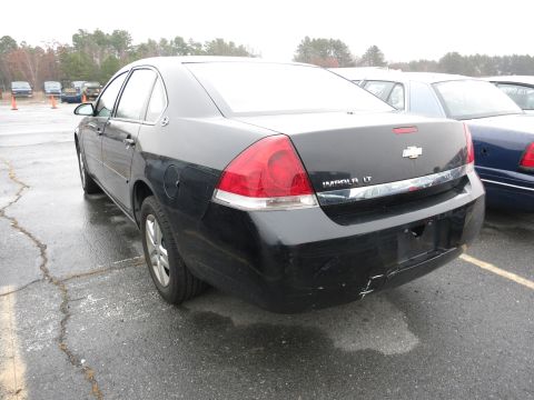 1991 Ford LTD Crown Victoria - Rear view of a black Chevrolet Impala LT parked outdoors.