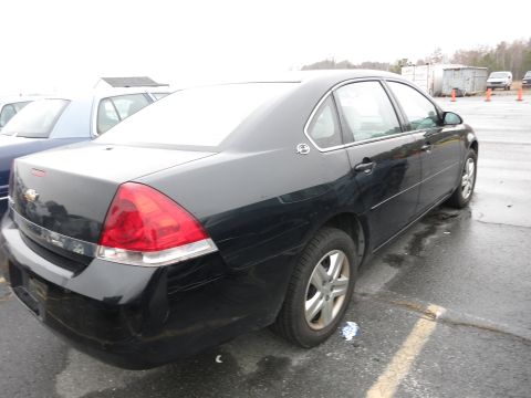 1991 Ford LTD Crown Victoria - Black sedan parked in an outdoor lot with other vehicles visible.