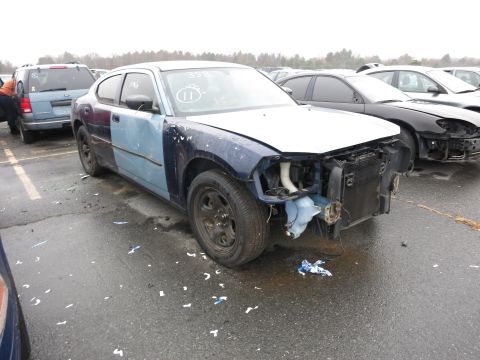 1991 Ford LTD Crown Victoria - A damaged Dodge Charger sits in a lot, missing its front bumper and grille, with mismatched body panels.