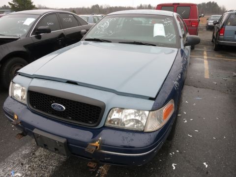 1991 Ford LTD Crown Victoria - A blue and light blue Ford Crown Victoria is parked in a lot with other vehicles. The hood is a lighter shade of blue than the rest of the…