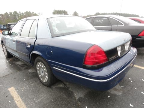 1991 Ford LTD Crown Victoria - A blue and light blue sedan is parked outdoors in a lot with other vehicles visible.