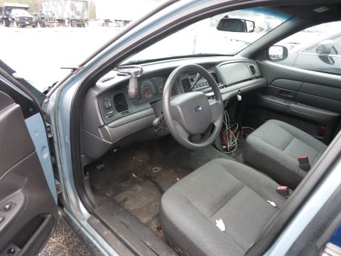 1991 Ford LTD Crown Victoria - Interior of a police car, showing the dashboard, steering wheel, and front seats. Wires are visible.