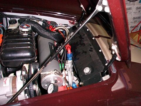 1967 Ford 427 - Close-up view of a vehicle's engine bay, highlighting an accusump system and associated plumbing.