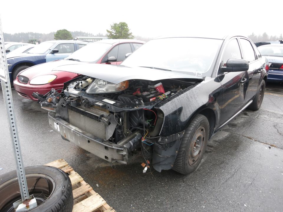 Black sedan with front-end damage, hood open, showing engine components