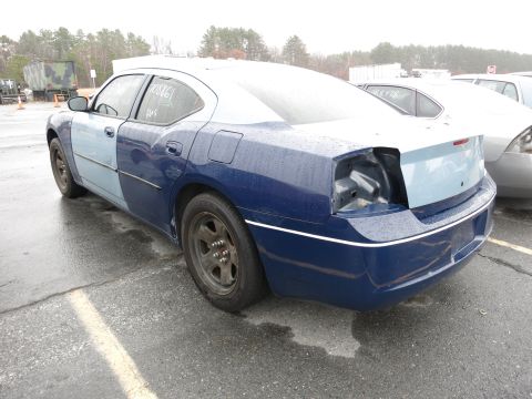 1991 Ford LTD Crown Victoria - This sedan, with its distinctive two-tone paint job and missing taillight, is seen from the rear in an outdoor lot.